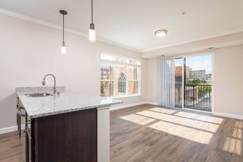 A kitchen and living room in a 555 waverly unit