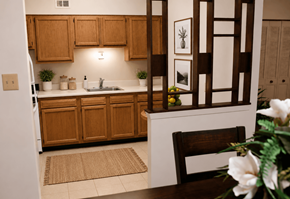 Essex apartment for rent - A kitchen with wooden cabinets and a white fridge.