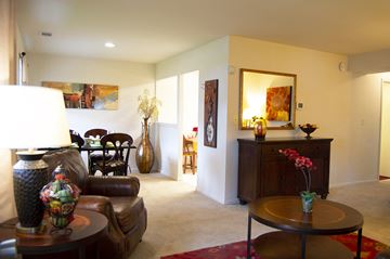 Parkville apartment for rent - A living room with a brown leather couch and a wooden coffee table.