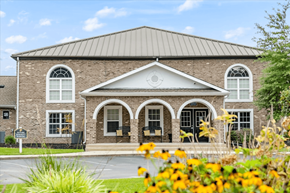Jacksonville apartment for rent - A building with a grey roof and a black door.