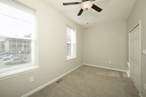 Baltimore apartment for rent - an empty bedroom with a ceiling fan and two windows at Queen Anne Belvedere, Baltimore, MD