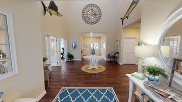 Little River apartment for rent - A living room with a rug and a circular decoration on the ceiling.