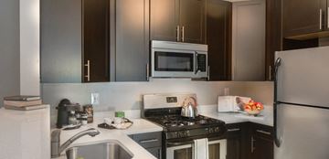North Bethesda apartment for rent - a kitchen with a stove and a sink and a microwave