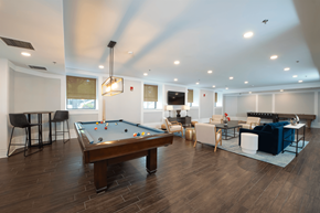 Baltimore apartment for rent - A billiard table is in the middle of a room with a pool table.