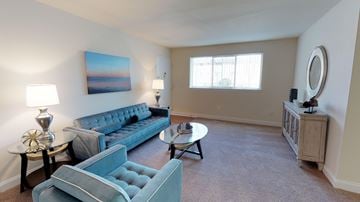Towson apartment for rent - a living room with blue couches and a table