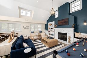 Annapolis apartment for rent - A blue sofa and a pool table are in a room with a fireplace. at Spa Cove Apartments, Annapolis, 21403