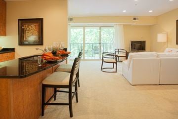 Annapolis apartment for rent - A living room with a white couch and a wooden bar.