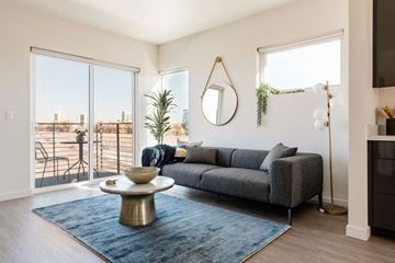 West Sacramento apartment for rent - a living room with a couch and a rug and a balcony