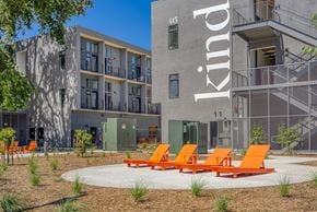 West Sacramento apartment for rent - a group of orange chairs in front of an apartment building