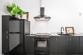 Sacramento apartment for rent - a kitchen with white walls and black cabinets