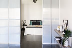 Sacramento apartment for rent - a bedroom with white walls and a bed with green pillows