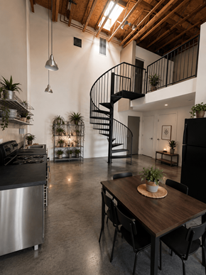 Sacramento apartment for rent - A modern kitchen with a stainless steel refrigerator and a wooden dining table.