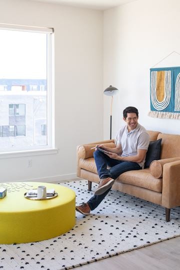 West Sacramento apartment for rent - a man sitting on a couch in a living room