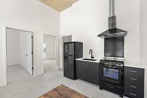 Sacramento apartment for rent - a kitchen with a stove top oven next to a refrigerator