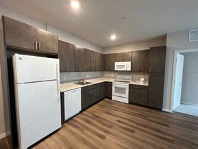 St. Paul apartment for rent - a kitchen with white appliances and wooden floors