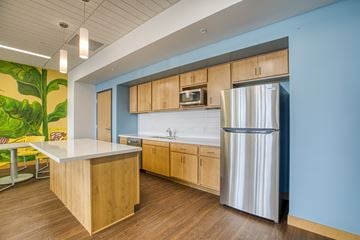 Duluth apartment for rent - A kitchen with a wooden island and a stainless steel refrigerator.
