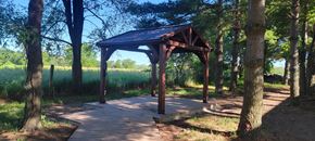 Ottumwa townhouse for rent - A wooden pavilion is situated in the middle of a wooded area.