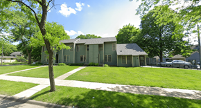 Minneapolis apartment for rent - A green house with a tree in front of it.