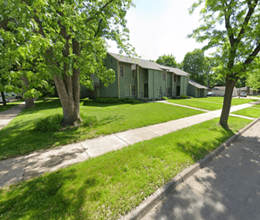 Minneapolis apartment for rent - A green house with a tree in front of it.
