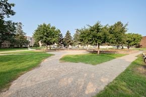 St Paul apartment for rent - A pathway with grass on either side leads to a building in the distance.