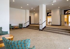 Marshalltown apartment for rent - A room with a carpeted floor and a staircase.