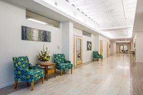 Marshalltown apartment for rent - A hallway with chairs and a table with flowers on it.
