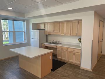 Duluth apartment for rent - A kitchen with wooden cabinets and a white island.