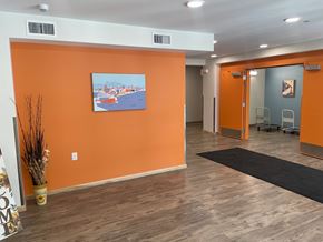 Duluth apartment for rent - A room with orange walls and a painting of a cityscape.