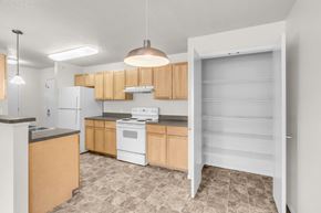 Minneapolis apartment for rent - A kitchen with wooden cabinets and a white refrigerator.