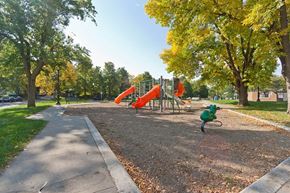 Des Moines apartment for rent - A playground with a red slide and a green ball.