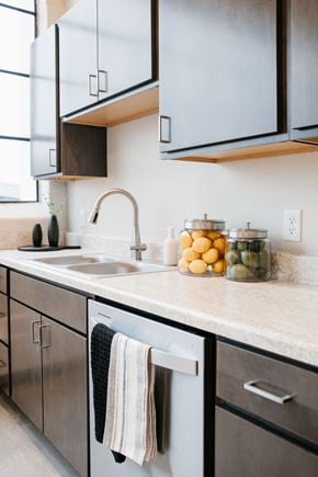 St Paul apartment for rent - A kitchen with a white sink and black cabinets.