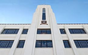 St Paul apartment for rent - A tall white building with a clock on the side.