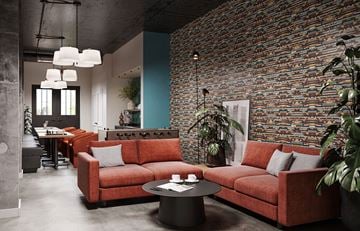 St Paul apartment for rent - A living room with a red couch and a brick wall.