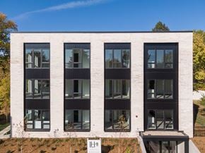 Minneapolis apartment for rent - A modern building with a white facade and black windows.