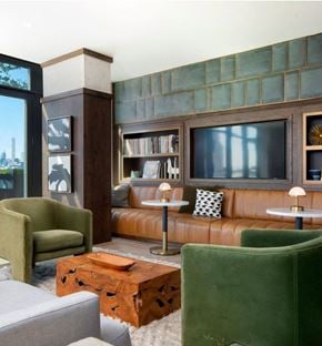 St Paul apartment for rent - A living room with a green chair and a brown leather couch.