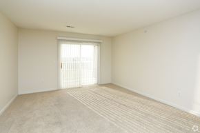 Blair apartment for rent - an empty living room with a door to a balcony