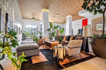 Bentonville apartment for rent - A living room with a grey sofa and a wooden coffee table.