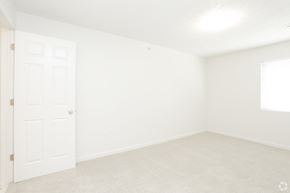 Blair apartment for rent - an empty bedroom with white walls and a white door