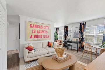 Kansas City apartment for rent - A living room with a couch and a poster that says "Kansas City is always a good idea".