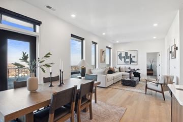 Omaha apartment for rent - A modern living room with a dining table and chairs.