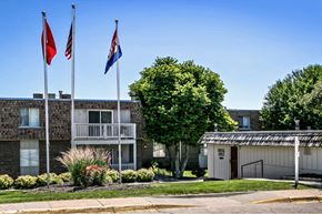 Bellevue apartment for rent - three flags flying in front of an apartment building