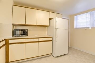 Omaha apartment for rent - A kitchen with a microwave on the counter and a refrigerator.