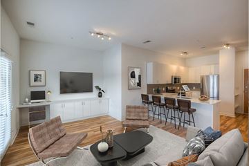 Omaha apartment for rent - A living room with a brown chair and a black coffee table.