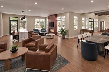Gretna townhouse for rent - A living room with brown leather furniture and a fireplace.