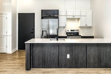Omaha apartment for rent - a kitchen with a white counter top and a stainless steel refrigerator