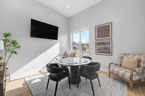 Rogers apartment for rent - A modern dining room with a round table and chairs.