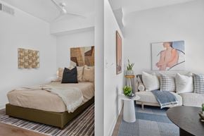 Bentonville apartment for rent - A bedroom with a bed and a couch.