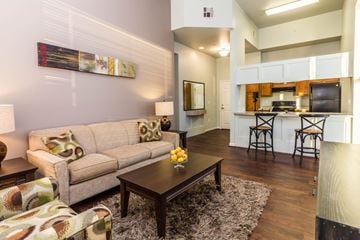 Wichita apartment for rent - A living room with a couch, a coffee table, and a painting on the wall.