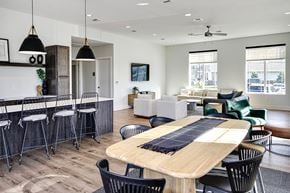 Bennington apartment for rent - A modern dining room with a wooden table and black chairs.