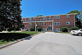 Omaha apartment for rent - a large brick building with a parking lot in front of it